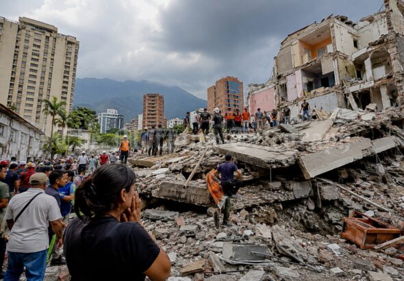 Rescue workers searching through rubble during the Venezuela earthquake crisis in La Guaira