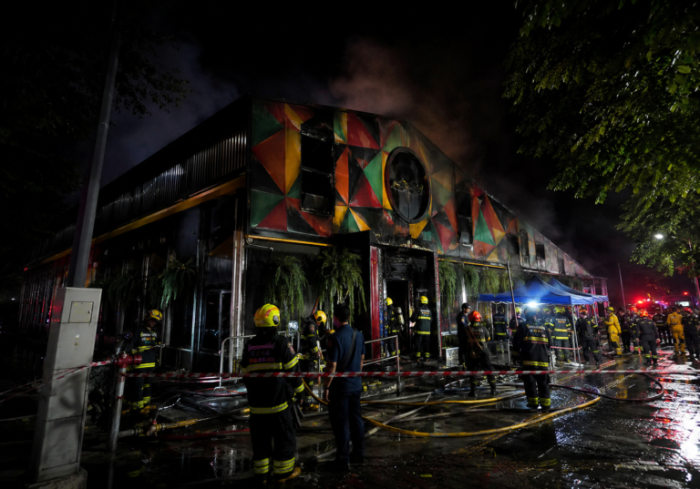 Emergency crews outside the scene of the Bangkok pub fire that killed at least 27 people and left 22 critically injured