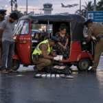 Police inspect a three-wheeler following the Mount Lavinia heroin arrest of a husband and wife near Ratmalana Airport junction.