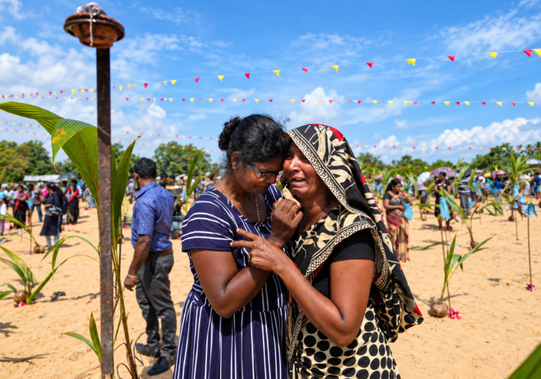 Women console each other at Chemmani in Jaffna, where the discovery of hundreds of human remains has prompted continuing forensic investigations and demands for answers.