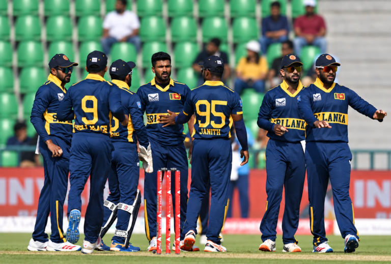 Sri Lankan cricketers amid green stadium seats